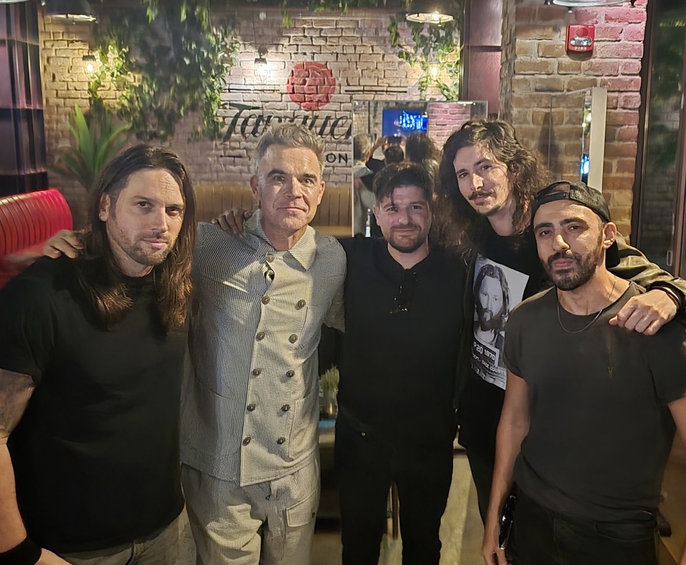 13 Daze posing together with a guest