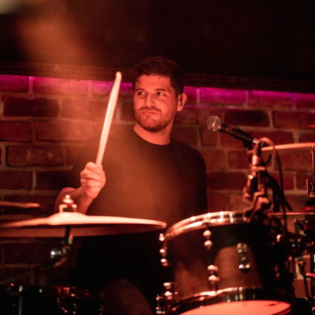 Dave Morrison playing drums on stage